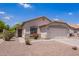 Charming single-story home with desert landscaping and a two-car garage on a clear, sunny day at 4518 W Carson Rd, Laveen, AZ 85339