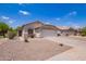Charming single-story home with desert landscaping and a two-car garage on a clear, sunny day at 4518 W Carson Rd, Laveen, AZ 85339