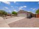 Single-story home featuring a two-car garage and low-maintenance desert landscaping, near a playground at 4518 W Carson Rd, Laveen, AZ 85339