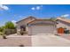 Charming single-story home featuring a two-car garage and low-maintenance desert landscaping in front yard at 4518 W Carson Rd, Laveen, AZ 85339