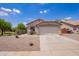 Charming single-story home featuring a two-car garage and low-maintenance desert landscaping in front yard at 4518 W Carson Rd, Laveen, AZ 85339