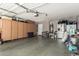 Spacious garage equipped with ample storage cabinets and a refrigerator at 4518 W Carson Rd, Laveen, AZ 85339