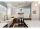 Well-lit kitchen featuring white upper cabinets, brown lower cabinets, and stainless steel appliances at 4518 W Carson Rd, Laveen, AZ 85339