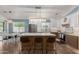 Spacious kitchen with stainless steel appliances, white cabinets, a large island, and modern lighting at 4518 W Carson Rd, Laveen, AZ 85339