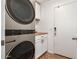 Modern laundry area featuring a stacked washer/dryer unit and adjacent countertop space at 4518 W Carson Rd, Laveen, AZ 85339