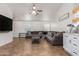 Open living space with tile flooring and large sectional sofa for comfortable living at 4518 W Carson Rd, Laveen, AZ 85339