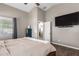 A view of the primary bedroom with TV and view into the en-suite at 4518 W Carson Rd, Laveen, AZ 85339