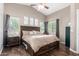 Inviting primary bedroom with natural light, ceiling fan, and wood-look floors at 4518 W Carson Rd, Laveen, AZ 85339