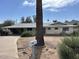 Single-story home featuring a covered carport and desert landscaping, with charming curb appeal at 4808 N 69Th St, Scottsdale, AZ 85251