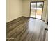 Bedroom featuring wood floors and a sliding glass door to the patio at 4850 E Desert Cove Ave # 241, Scottsdale, AZ 85254