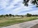 Scenic view of the golf course featuring rolling greens, mature trees, and a clear blue sky at 4850 E Desert Cove Ave # 241, Scottsdale, AZ 85254