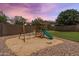 This backyard features a charming playset for and a manicured putting green, perfect for Gathering fun at 6299 S Roanoke St, Gilbert, AZ 85298