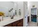 Bathroom featuring a vanity with a large mirror and access to the home office at 6299 S Roanoke St, Gilbert, AZ 85298