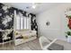 Cozy bedroom with floral wallpaper, a daybed, plantation shutters, and plank flooring at 6299 S Roanoke St, Gilbert, AZ 85298