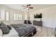 Main bedroom features a dark wood bed frame, light hardwood floors, and large windows at 6299 S Roanoke St, Gilbert, AZ 85298