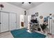 Well-lit bedroom with wood-look floors, a closet, and a dedicated workspace at 6299 S Roanoke St, Gilbert, AZ 85298