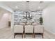 Dining room featuring accent wall and modern light fixture at 6299 S Roanoke St, Gilbert, AZ 85298