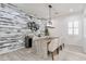 Dining room features a modern light fixture and a rustic accent wall at 6299 S Roanoke St, Gilbert, AZ 85298