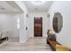 Welcoming foyer featuring neutral tones, stylish decor, wood-look flooring, and an elegant front door at 6299 S Roanoke St, Gilbert, AZ 85298