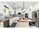 Open kitchen featuring a large island, stainless steel appliances, and white cabinets at 6299 S Roanoke St, Gilbert, AZ 85298
