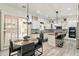 Modern eat-in kitchen featuring white cabinetry, stainless steel appliances, and a stylish dining area at 6299 S Roanoke St, Gilbert, AZ 85298