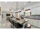 Open concept kitchen with large island, stainless steel appliances, and bar stool seating at 6299 S Roanoke St, Gilbert, AZ 85298