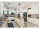 Open floor plan kitchen with large island, granite counters, stainless appliances, and white cabinets at 6299 S Roanoke St, Gilbert, AZ 85298