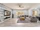 Spacious living room with modern wood-look accent wall, cozy seating, and abundant natural light at 6299 S Roanoke St, Gilbert, AZ 85298