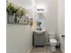 Small powder room featuring a basket full of flowers and a round mirror above the vanity at 6299 S Roanoke St, Gilbert, AZ 85298