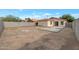 A spacious backyard with dirt landscaping and a newly poured concrete patio area, perfect for outdoor entertaining at 6434 W Riva Rd, Phoenix, AZ 85043