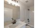 The bathroom is well-lit and updated, featuring tiled shower and tub, bright white walls, and white cabinets at 6434 W Riva Rd, Phoenix, AZ 85043