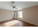 A bright bedroom with a ceiling fan and wood flooring, offering ample space and natural light at 6434 W Riva Rd, Phoenix, AZ 85043