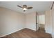 Cozy bedroom enhanced by modern ceiling fan and wood flooring, with an adjacent door offering easy access to other areas at 6434 W Riva Rd, Phoenix, AZ 85043