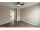 Light filled bedroom features modern ceiling fan, wood flooring and access to the backyard from the sliding glass door at 6434 W Riva Rd, Phoenix, AZ 85043