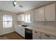 Bright kitchen featuring white cabinets, subway tile backsplash, modern appliances, and beautiful wood-look flooring at 6434 W Riva Rd, Phoenix, AZ 85043