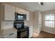 Kitchen boasts stainless steel microwave and black oven, with white countertops and sleek hardware and an adjacent dining area at 6434 W Riva Rd, Phoenix, AZ 85043