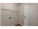 Bright laundry room features sleek, white walls, convenient shelving, and hardwood floors at 6434 W Riva Rd, Phoenix, AZ 85043