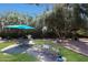 Backyard featuring a patio with seating area, lush grass, and mature shade trees at 6911 E Thunderbird Rd, Scottsdale, AZ 85254