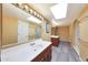 Bright and spacious bathroom featuring dual vanities, wood cabinets, and a shower at 6911 E Thunderbird Rd, Scottsdale, AZ 85254