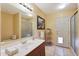 Bright bathroom featuring tile flooring, a large mirror, single sink vanity, and walk-in shower at 6911 E Thunderbird Rd, Scottsdale, AZ 85254