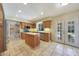 Well-lit kitchen with modern appliances, island, and backyard access at 6911 E Thunderbird Rd, Scottsdale, AZ 85254