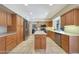 Spacious kitchen featuring an island, tile floors and stainless steel appliances at 6911 E Thunderbird Rd, Scottsdale, AZ 85254