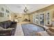 Comfortable living room with stone fireplace and french doors leading to the backyard at 6911 E Thunderbird Rd, Scottsdale, AZ 85254