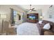 Cozy living room with neutral tones, ceiling fan, entertainment center, and bright window at 6911 E Thunderbird Rd, Scottsdale, AZ 85254