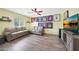 Spacious living room with light yellow walls, ceiling fan, wood-look floors, leather sofas and wall decor at 6911 E Thunderbird Rd, Scottsdale, AZ 85254
