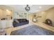 Open living room featuring a stone fireplace and wet bar area at 6911 E Thunderbird Rd, Scottsdale, AZ 85254
