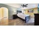Spacious main bedroom with a queen bed, ceiling fan, and wood-look floors at 6911 E Thunderbird Rd, Scottsdale, AZ 85254