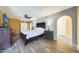 Bright main bedroom featuring a queen bed, stylish decor, and wood-look floors at 6911 E Thunderbird Rd, Scottsdale, AZ 85254