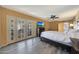 Sunny main bedroom with a queen bed, outdoor views, and wood-look floors at 6911 E Thunderbird Rd, Scottsdale, AZ 85254