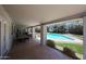 Covered patio overlooking the pool with dining and seating space at 6911 E Thunderbird Rd, Scottsdale, AZ 85254